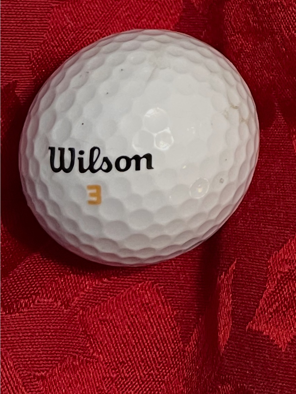 Wilson White Golf Ball with Black Logo and Gold Number